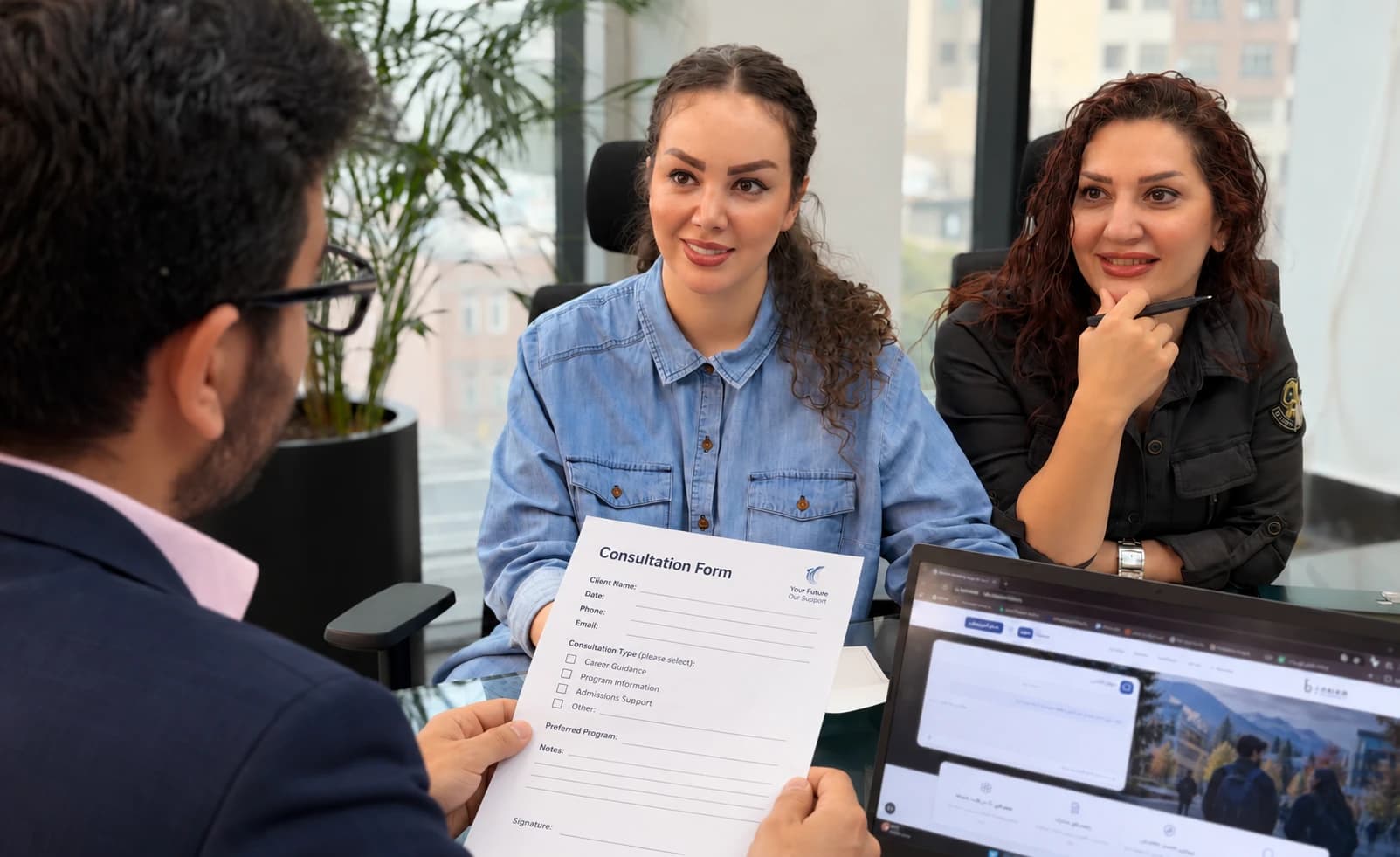 An advisor discussing study plans with two applicants